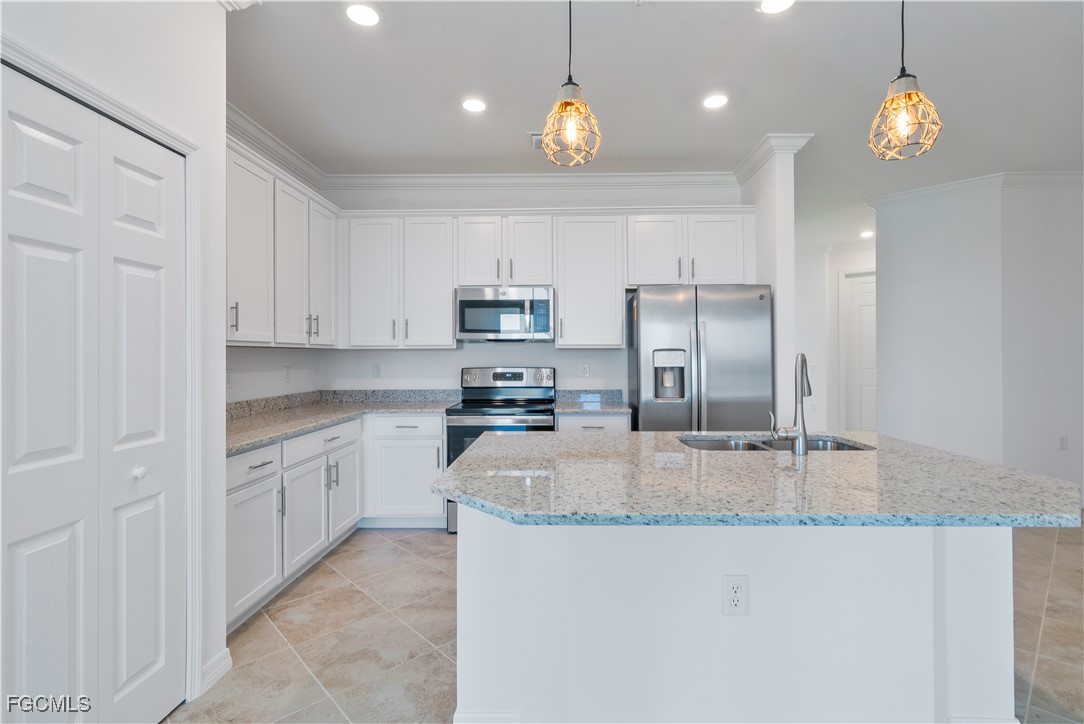 43977 Boardwalk Loop, Unit 2338 Punta Gorda, FL 33982 - Photo 9 of 50 a kitchen with kitchen island granite countertop a stove a sink a refrigerator and a granite counter tops