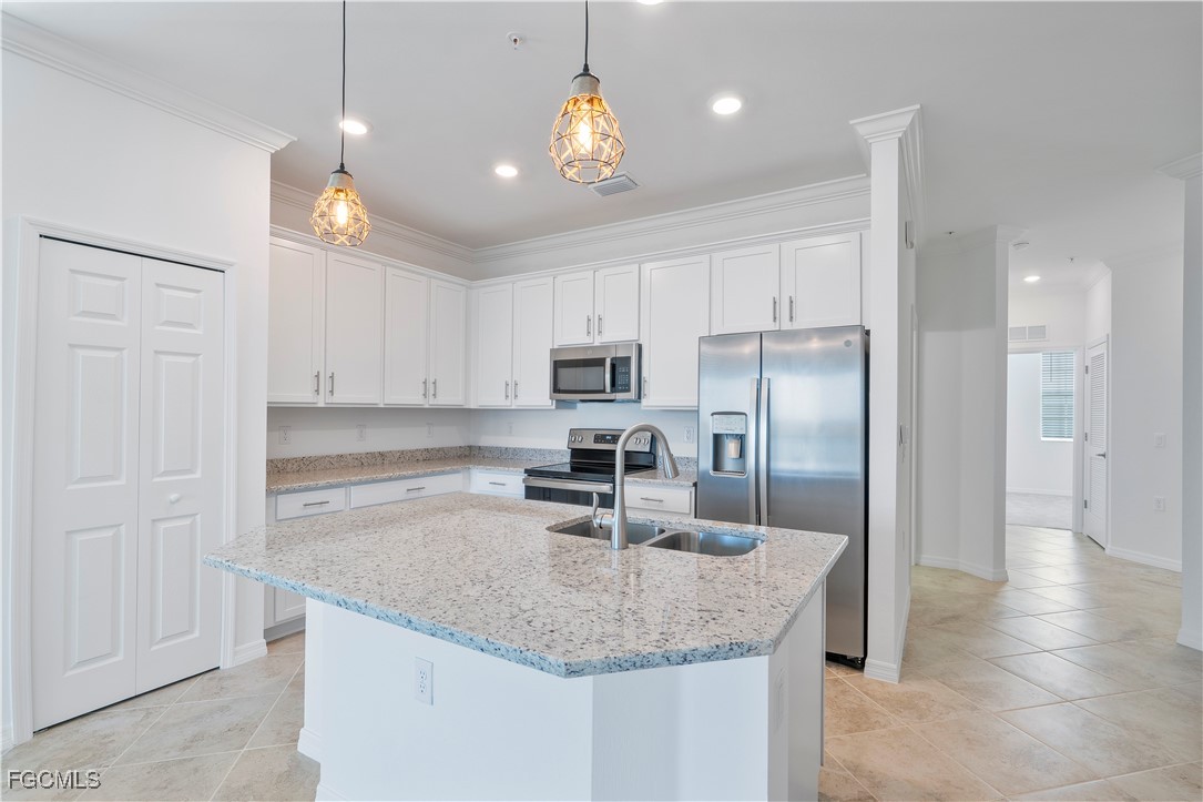 43977 Boardwalk Loop, Unit 2338 Punta Gorda, FL 33982 - Photo 10 of 50 a kitchen with kitchen island granite countertop a sink center island and stainless steel appliances