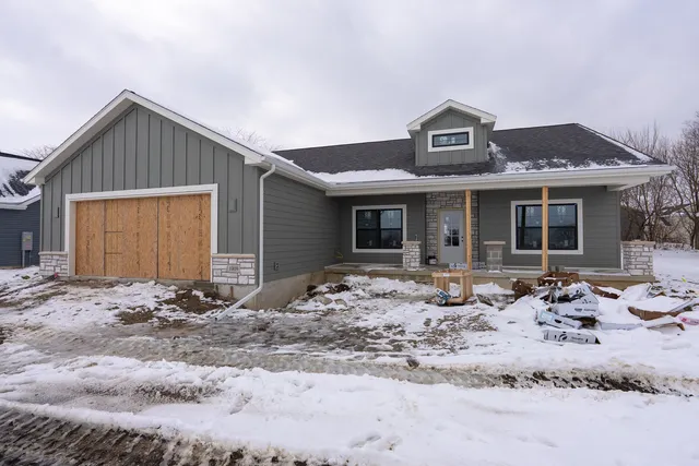 a front view of a house with yard and seating space