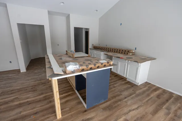 a view of kitchen with sink and refrigerator