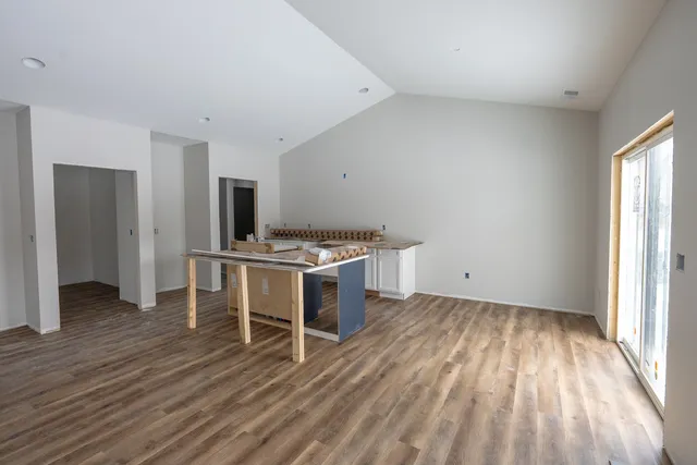 a kitchen with granite countertop white cabinets and a sink