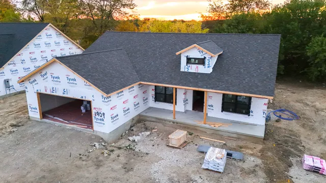an aerial view of a house with a yard