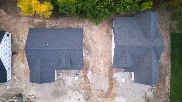 an aerial view of a house with garden space and street view