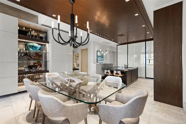 a living room with furniture a chandelier and a window