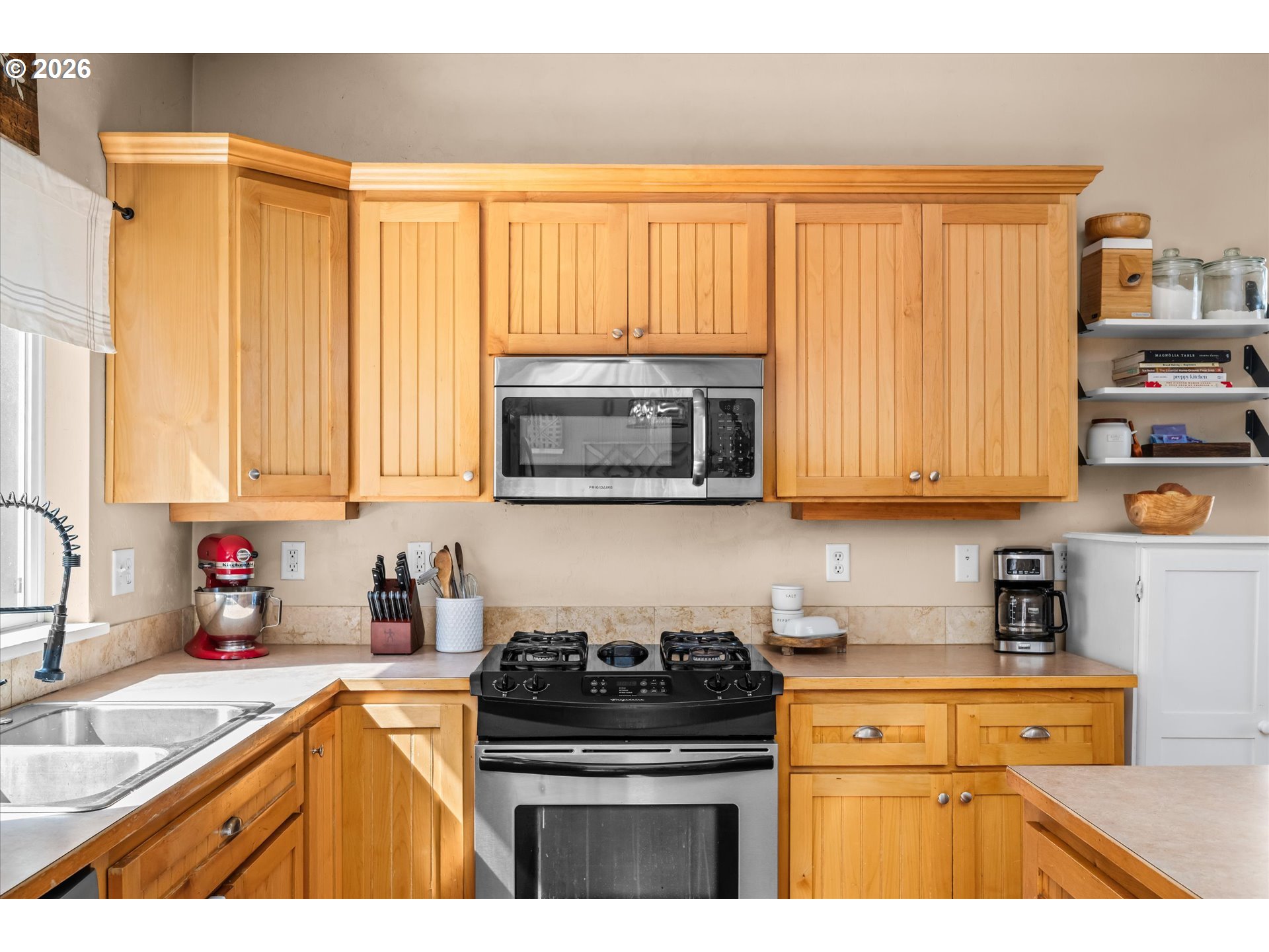 277 South 67th Court Springfield, OR 97478 - Photo 11 of 44 a kitchen with stainless steel appliances granite countertop a stove a sink and a microwave