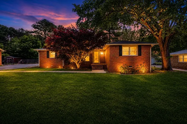 a front view of a house with garden