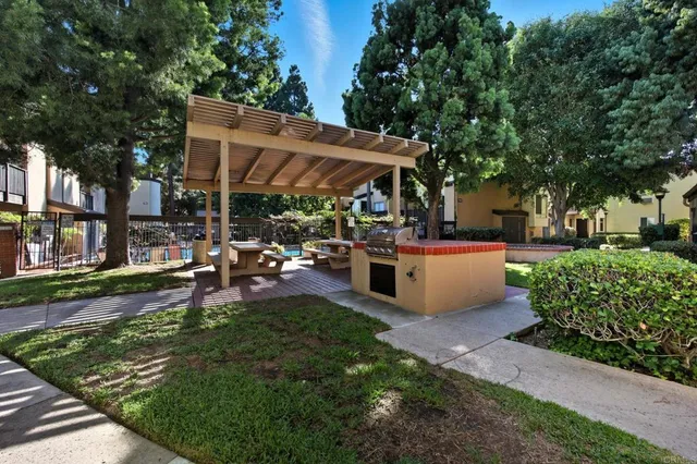 a view of a patio with table and chairs under an umbrella