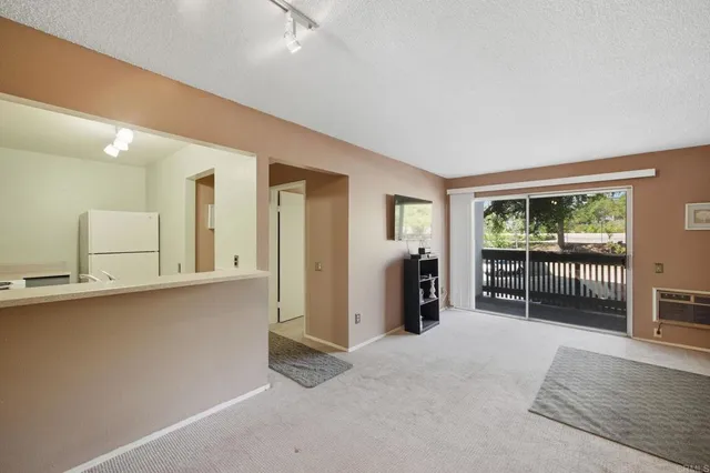 a spacious bedroom with a balcony a bed and a large window