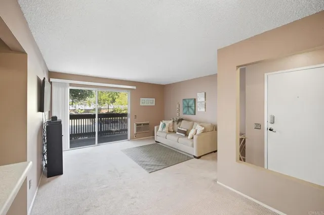 a spacious bedroom with a bed and glass door