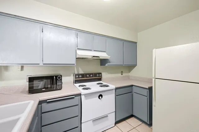 a kitchen with a stove a refrigerator and a sink