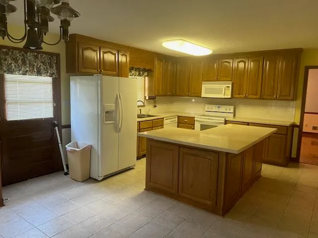 a kitchen with stainless steel appliances a refrigerator sink and cabinets