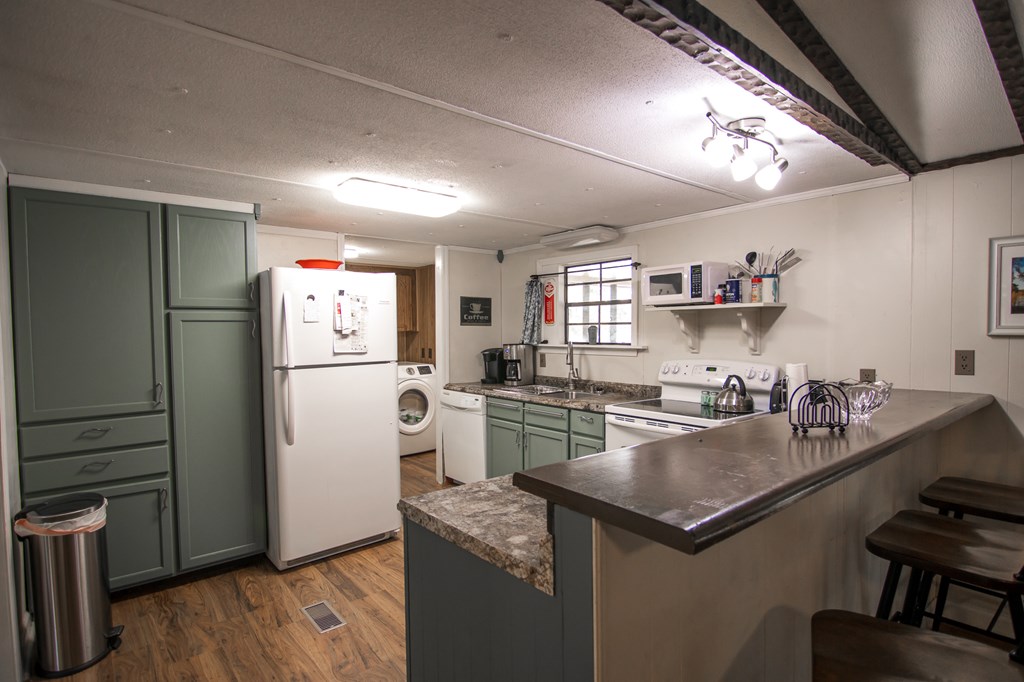 1631 West Pine Lake Drive West Point, GA 31833 - Photo 13 of 37 a kitchen with refrigerator and cabinets