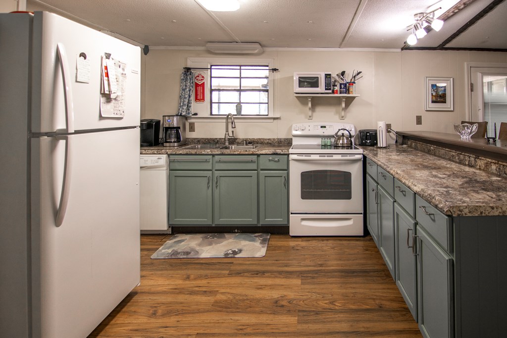 1631 West Pine Lake Drive West Point, GA 31833 - Photo 14 of 37 a kitchen with stainless steel appliances granite countertop a refrigerator and a sink
