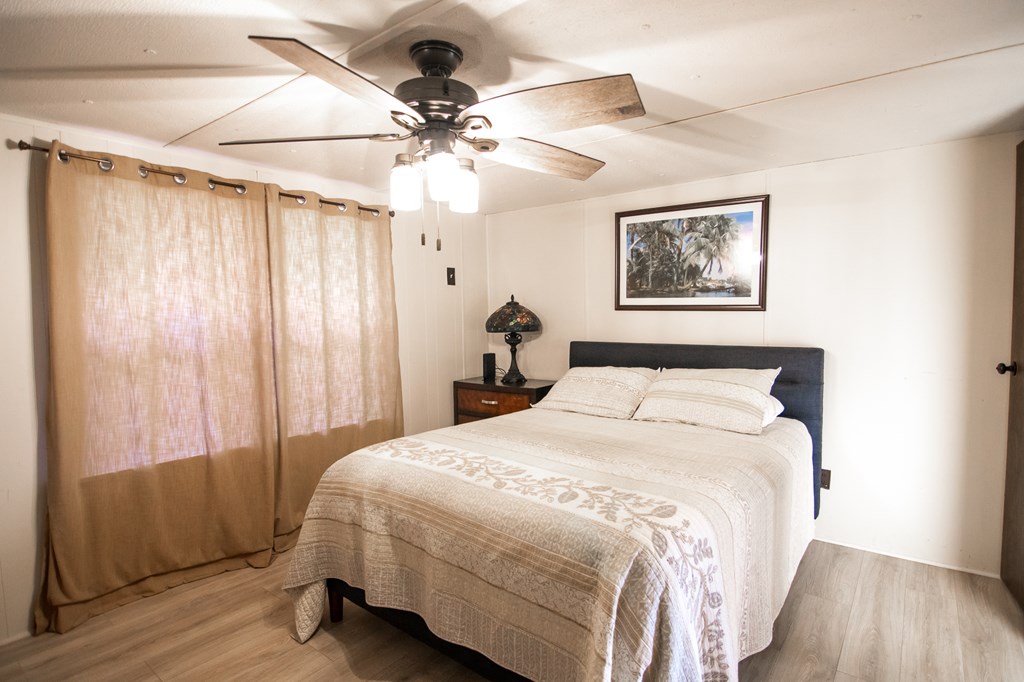 1631 West Pine Lake Drive West Point, GA 31833 - Photo 17 of 37 a bedroom with a bed and a chandelier