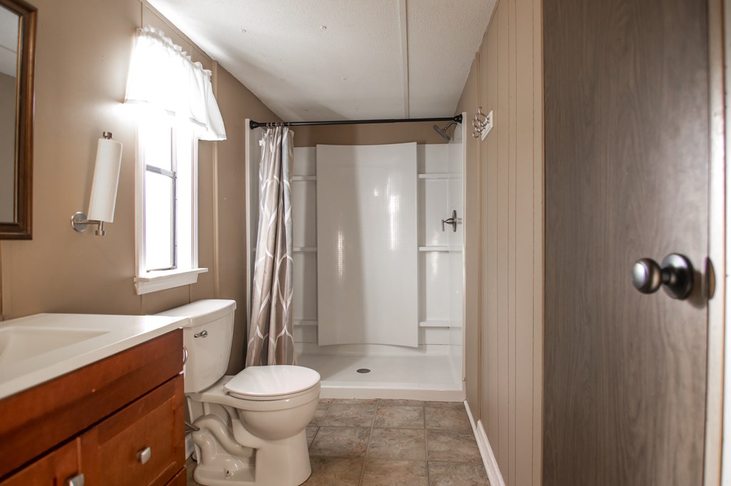 1631 West Pine Lake Drive West Point, GA 31833 - Photo 20 of 37 a bathroom with a sink toilet and shower