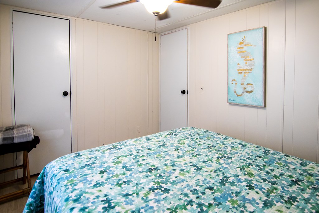 1631 West Pine Lake Drive West Point, GA 31833 - Photo 25 of 37 a bedroom with a bed and a painting on the wall