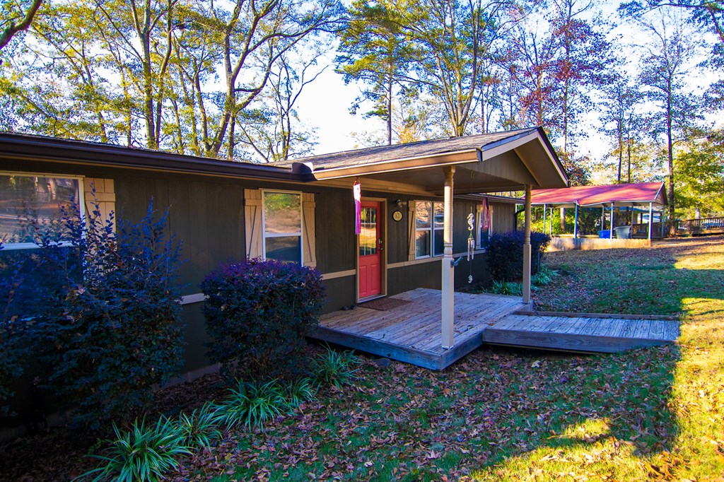 1631 West Pine Lake Drive West Point, GA 31833 - Photo 6 of 37 a view of patio with a table and chairs under an umbrella