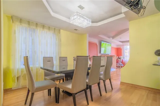 a view of a dining room with furniture and chandelier