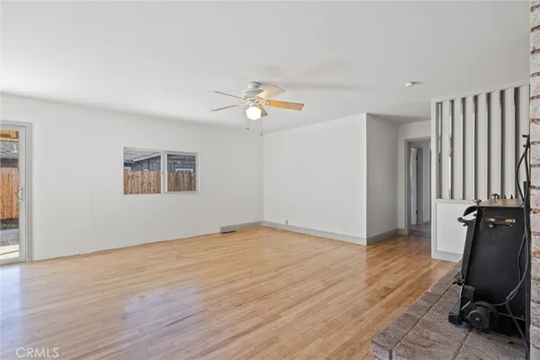 wooden floor in an empty room with a window