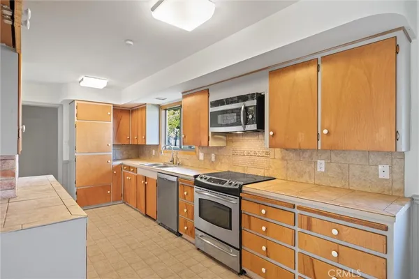 a kitchen with a sink and a window