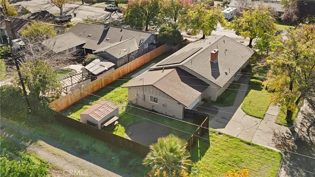 an aerial view of a house with a yard