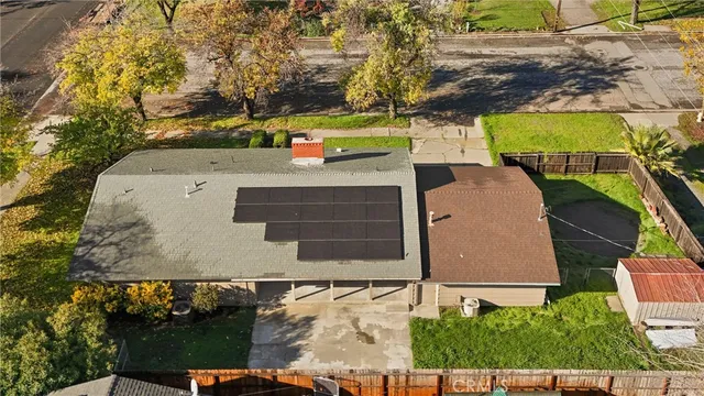 an aerial view of a house with a yard