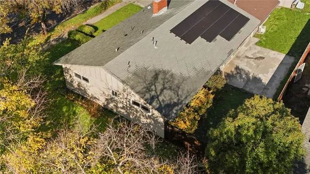 an aerial view of residential building and ocean view in back