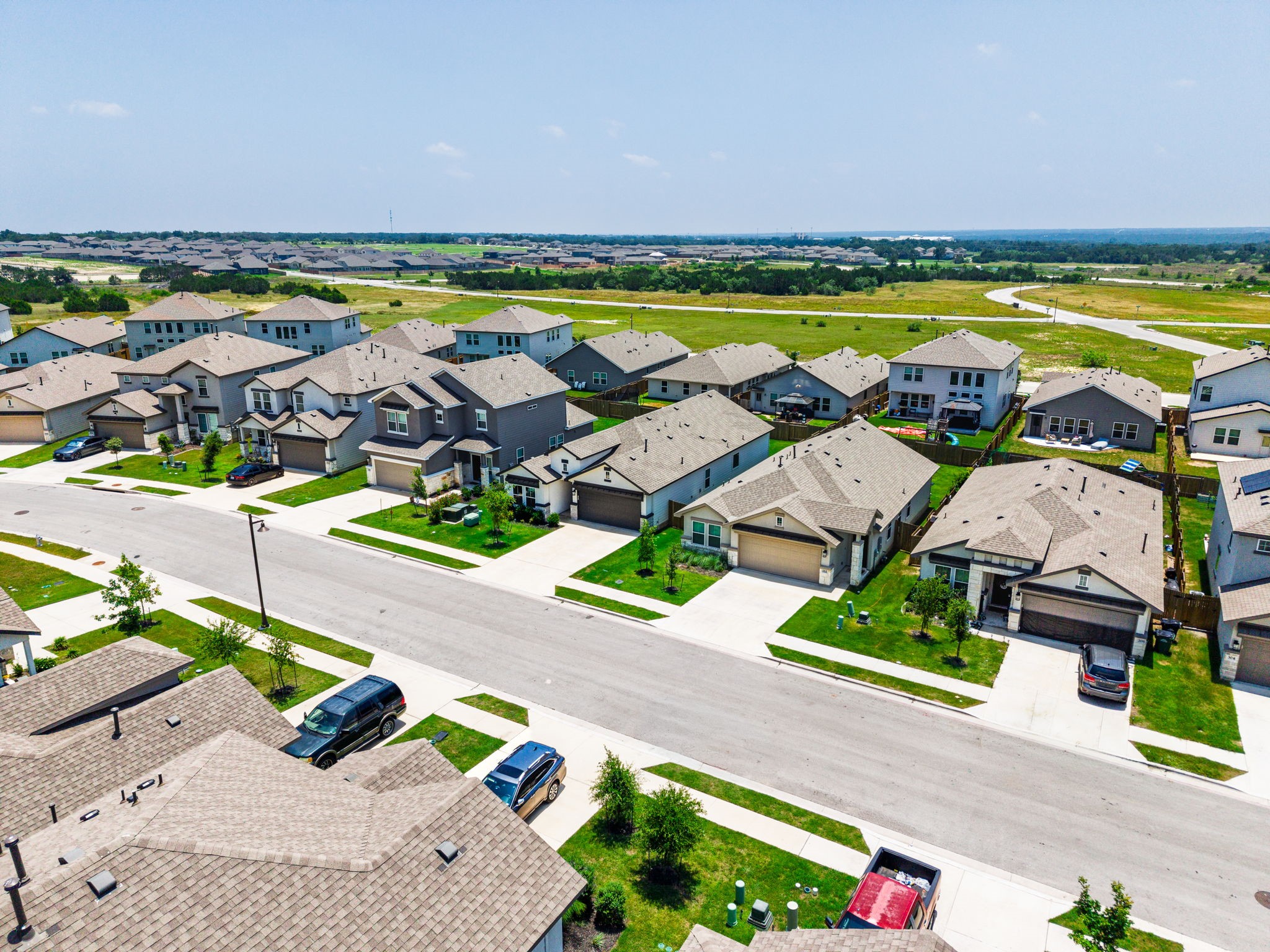 316 Windstar Road Liberty Hill, TX 78642 - Photo 27 of 27 an aerial view of residential houses with swimming pool and ocean view