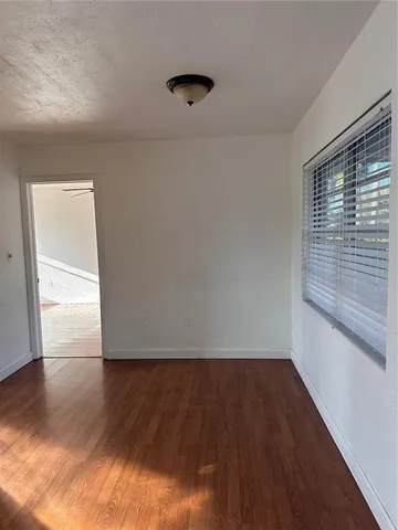 a view of wooden floor and windows in a room