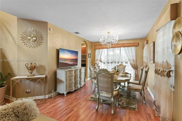 a kitchen with a refrigerator and a stove top oven