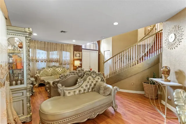 a kitchen with stainless steel appliances granite countertop a sink and a refrigerator