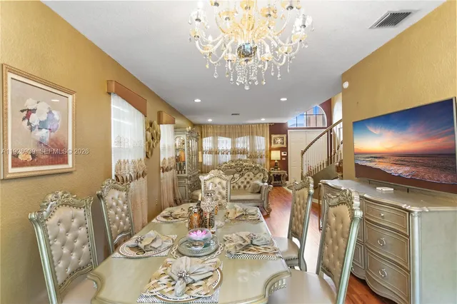 a kitchen with stainless steel appliances kitchen island granite countertop a refrigerator and a stove