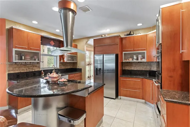 a view of a room with gym equipment and a flat screen tv