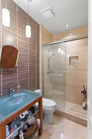 a bedroom with a large bed and wooden floor