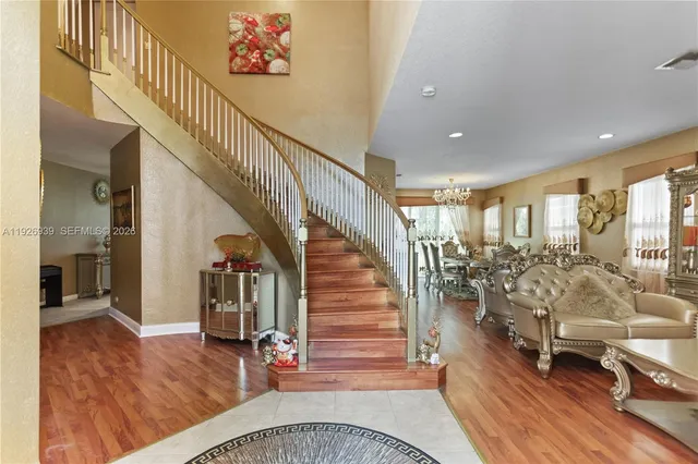 a living room with furniture a rug and a large window