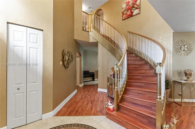 a dining room with furniture chandelier and wooden floor