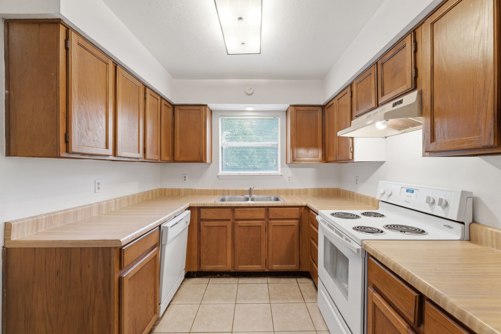 6914 Ten Curves Road Spring, TX 77379 - Photo 9 of 26 Kitchen lined in cabinetry with backyard views.