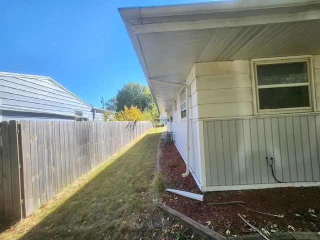 a view of a pathway of a house with a yard