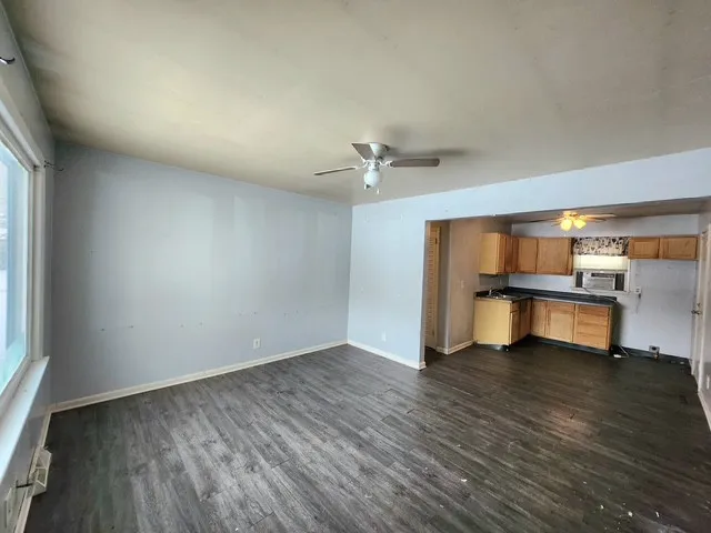 wooden floor in an empty room with a window