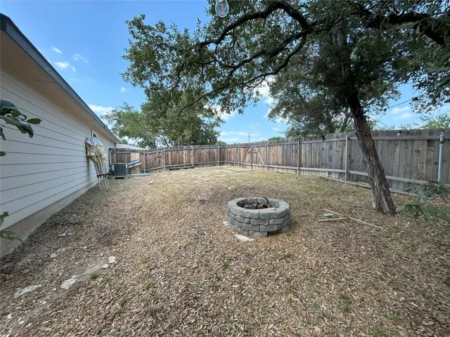 a view of a house with a yard and sitting area