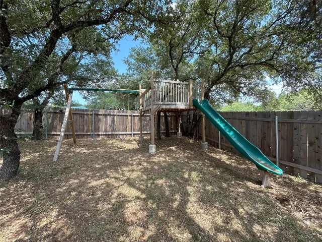 a view of a backyard with a plants and trees