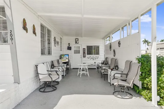 a living room with furniture a flat screen tv and a table