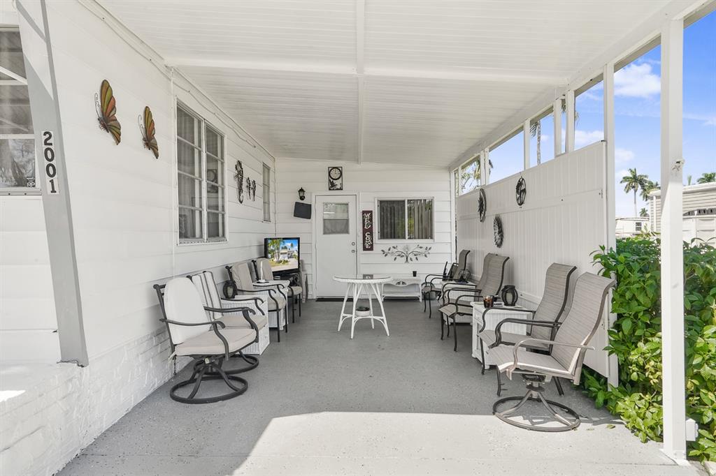 2001 Southwest 84th Avenue Davie, FL 33324 - Photo 12 of 38 a living room with furniture a flat screen tv and a table