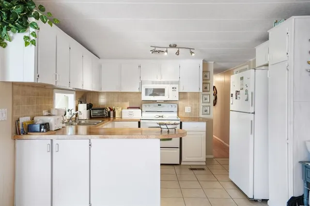 a kitchen with refrigerator cabinets and a sink