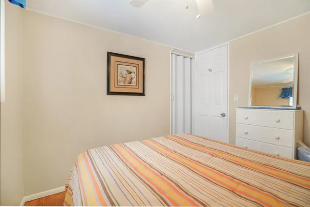 a bedroom with a bed and a mirror