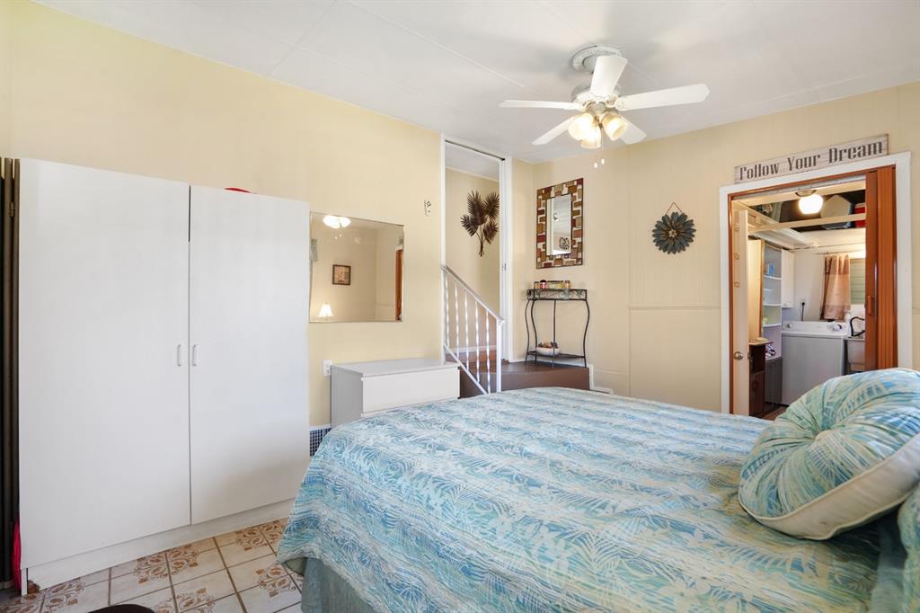 2001 Southwest 84th Avenue Davie, FL 33324 - Photo 29 of 38 a bedroom with a bed and a chandelier