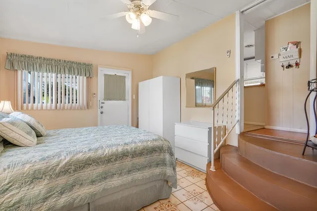 a bedroom with a large bed and a chandelier