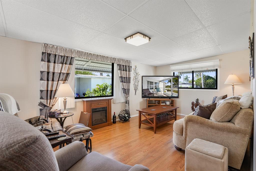 2001 Southwest 84th Avenue Davie, FL 33324 - Photo 4 of 38 a living room with furniture a flat screen tv and a fireplace