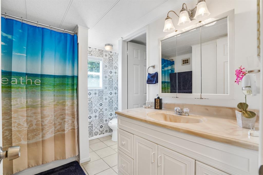 2001 Southwest 84th Avenue Davie, FL 33324 - Photo 6 of 38 a bathroom with a shower sink and mirror