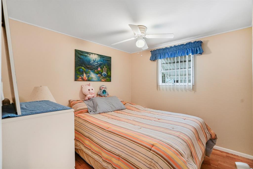 2001 Southwest 84th Avenue Davie, FL 33324 - Photo 7 of 38 a bedroom with a large bed and a chandelier